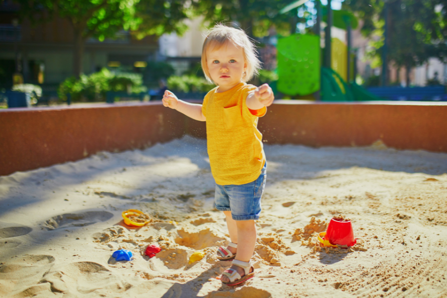 toddler in sandpit